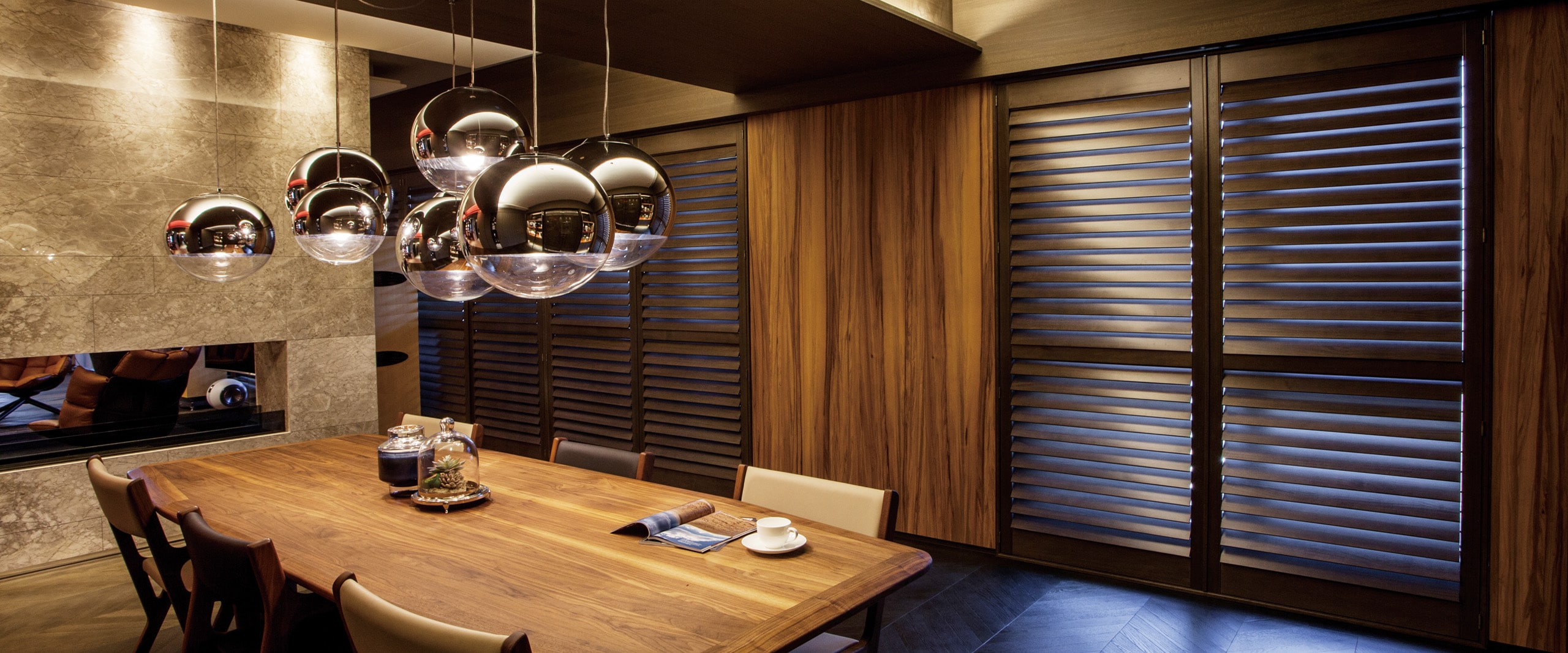 An elegant dining area with Normandy Ultra shutters