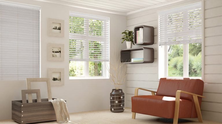 a room with a sofa and windows with Normandy wood blinds